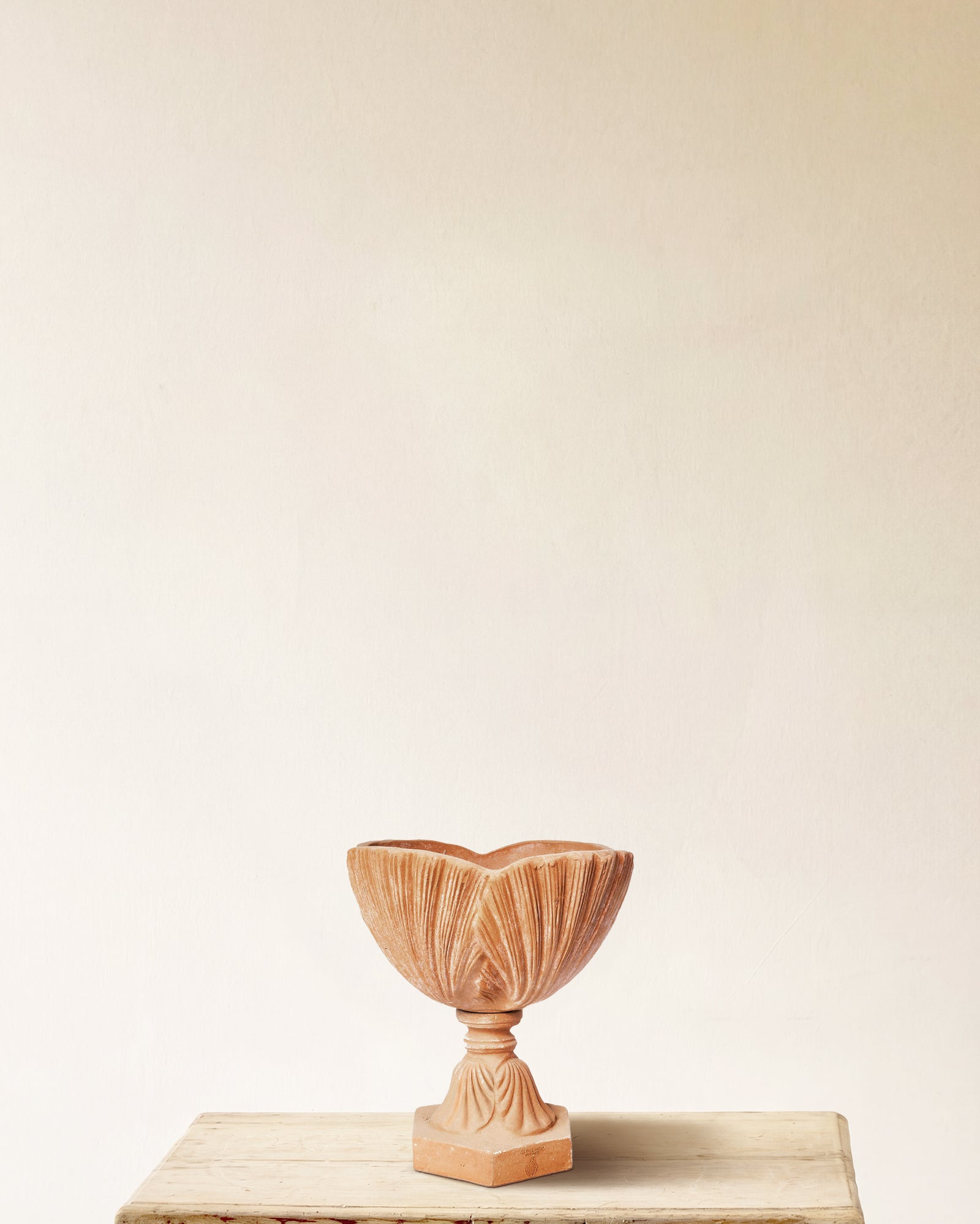 Shell shaped footed urn