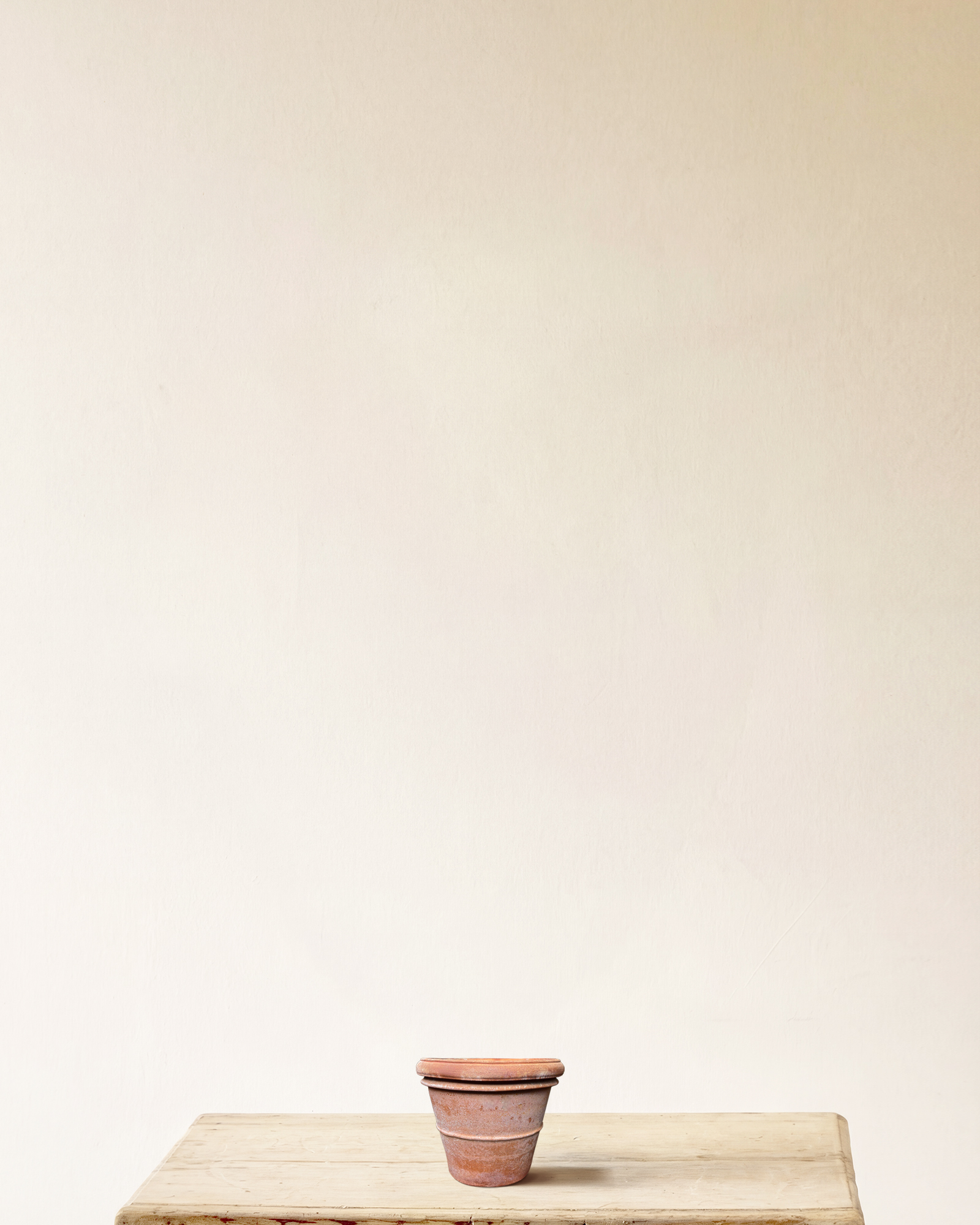 Italian terracotta planter with rounded form and wide rolled rim, smooth surface, made in Impruneta, 7" x 6"
